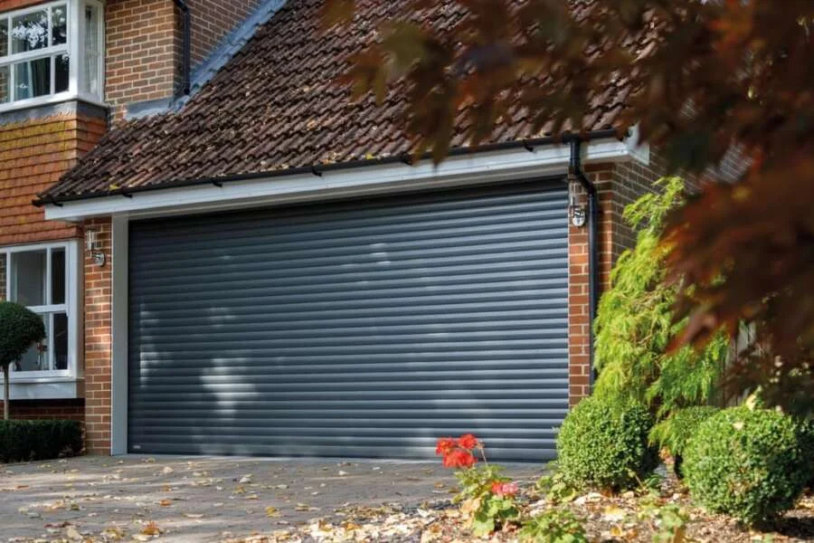 Anthracite roller garage door fitted to a traditional brick house