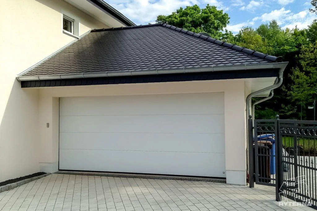 White sectional garage door installed on a modern home
